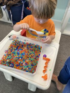 Child using a sensory bin during occupational therapy in Jacksonville ,Florida.